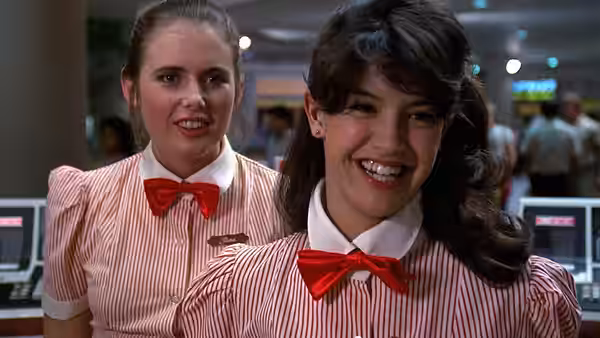 Stacy Hamilton (Jennifer Jason Leigh) and Linda Barrett (Phoebe Cates) smiling in uniforms