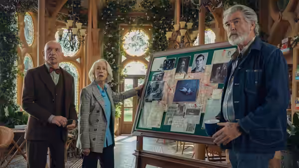 Elizabeth pointing at investigation board while Ibrahim and Ron look on