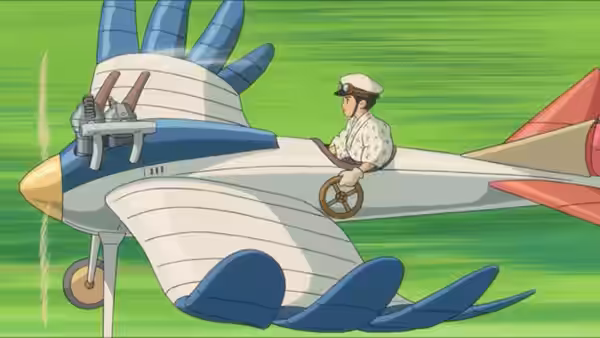 A man in a cap pilots a small propeller plane over green countryside