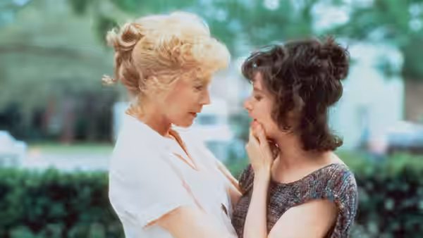 Aurora (Shirley MacLaine) touching Emma (Debra Winger) on the chin outdoors