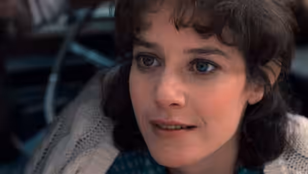 Emma (Debra Winger) looking ahead with a concerned expression