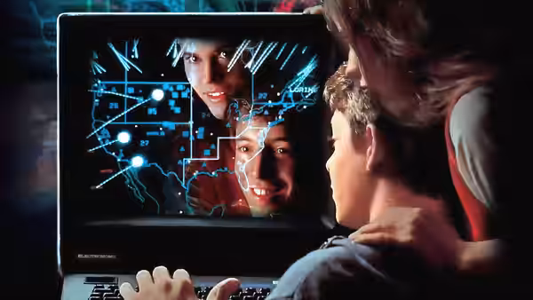 David Lightman (Matthew Broderick) and Jennifer (Ally Sheedy) examining a laptop display