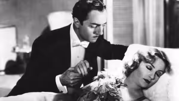 Godfrey (William Powell) leans over Irene Bullock (Carole Lombard), who rests on a bed
