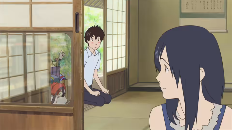 Kenji sits in a doorway behind Natsuki inside a traditional Japanese house