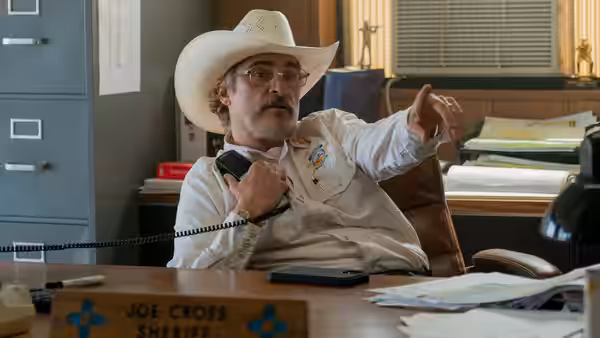 Joe Cross (Joaquin Phoenix) on the phone in his sheriff office