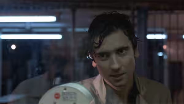 Paul Hackett (Griffin Dunne) grips a device while standing in the rain at night