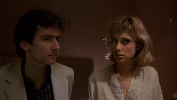Paul Hackett (Griffin Dunne) and Gail (Catherine O'Hara) stare ahead in a dim room