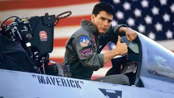 Maverick (Tom Cruise) gives a thumbs up from a jet cockpit