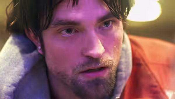Connie Nikas in close-up with a wet face and red jacket