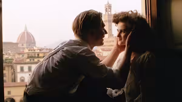 George Emerson (Julian Sands) touching Lucy Honeychurch (Helena Bonham Carter) by a window in Florence