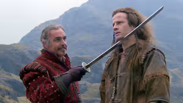 Ramirez (Sean Connery) raises a sword beside Connor MacLeod (Christopher Lambert) in the mountains