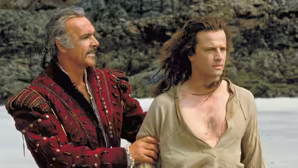Ramirez (Sean Connery) stands with Connor MacLeod (Christopher Lambert) on a rocky shore