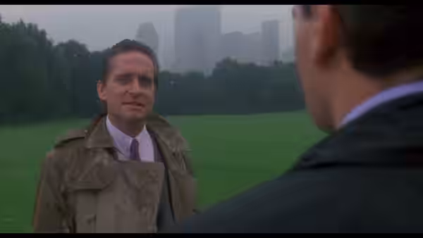 Gordon Gekko (Michael Douglas) stands in a park facing another man