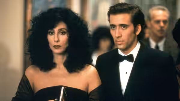 Loretta Castorini (Cher) and Ronny Cammareri (Nicolas Cage) standing side by side in formal wear