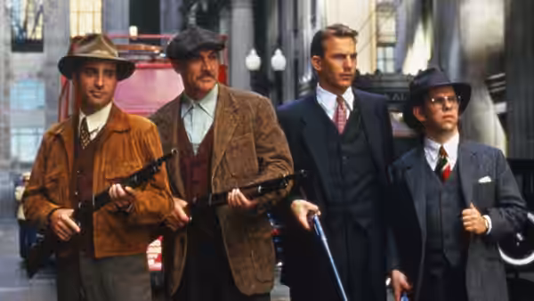 Jim Malone (Sean Connery) and Eliot Ness (Kevin Costner) with two armed men on a street
