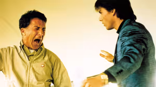 Dustin Hoffman shouting at a man in a blue jacket