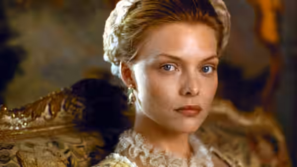 Madame de Tourvel (Michelle Pfeiffer) looks ahead with a serious expression