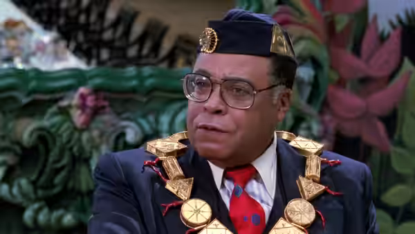 King Jaffe Joffer (James Earl Jones) wearing a fez and gold chains