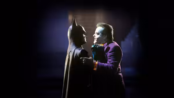 Joker (Jack Nicholson) gripping Batman (Michael Keaton) by the chest in darkness