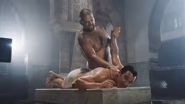 Hubert Bonisseur de La Bath (Jean Dujardin) lies on a bathhouse table as an attendant scrubs him
