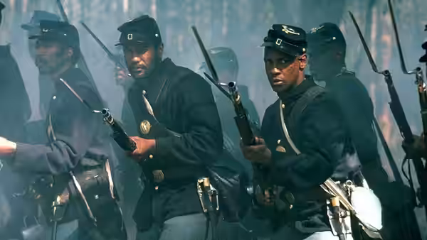 Union soldiers advancing through smoke holding rifles at the ready