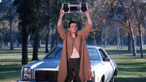Lloyd Dobler (John Cusack) holding a boombox over his head beside a car