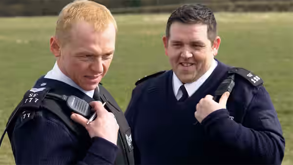 Nicholas Angel (Simon Pegg) and Danny Butterman (Nick Frost) checking radios outdoors