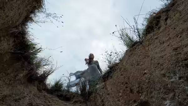 Mrs. O'Brien standing in a grassy ravine looking upward
