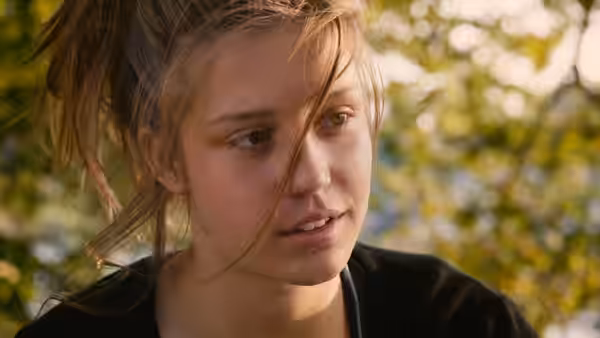 Adèle (Adèle Exarchopoulos) with windblown hair gazing aside in daylight