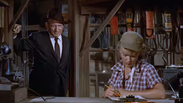 John J. Macreedy enters the store as Liz Wirth writes at the counter