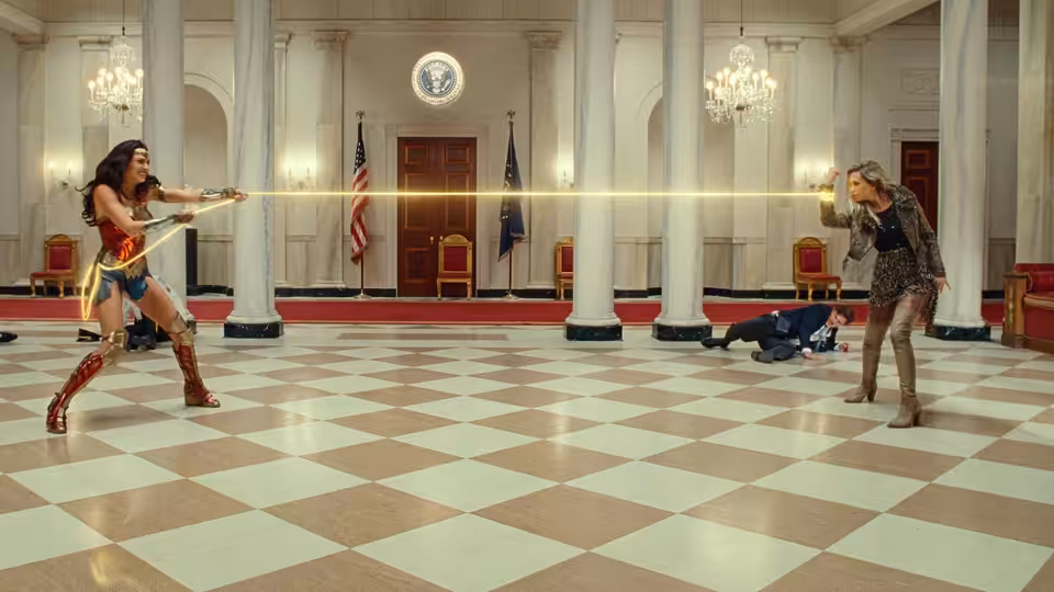 Diana Prince (Gal Gadot) fires her lasso across a marble hall at Barbara Minerva (Kristen Wiig)