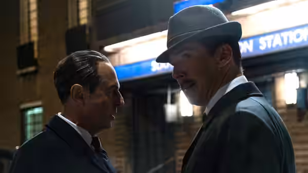 Greville Wynne (Benedict Cumberbatch) talks with a man outside a railway station