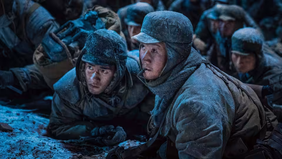 Wu Qianli and Wu Wanli crouch with fellow soldiers in a snow-covered battlefield