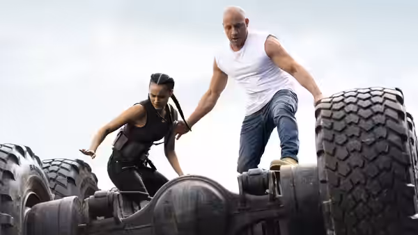 Dominic Toretto (Vin Diesel) and Letty Ortiz (Michelle Rodriguez) balance atop an oversized vehicle