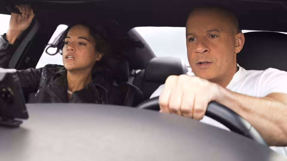 Dominic Toretto (Vin Diesel) drives while Letty Ortiz (Michelle Rodriguez) rides beside him