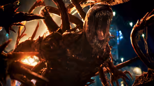 Carnage roars with tendrils outstretched amid bright lights