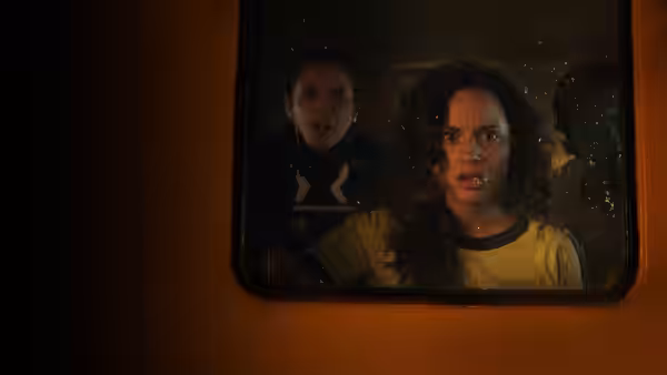 Deena (Kiana Madeira) and Samantha (Olivia Scott Welch) peer through a window
