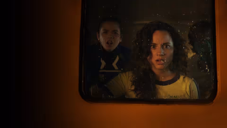 Deena (Kiana Madeira) and Samantha (Olivia Scott Welch) peer through a window