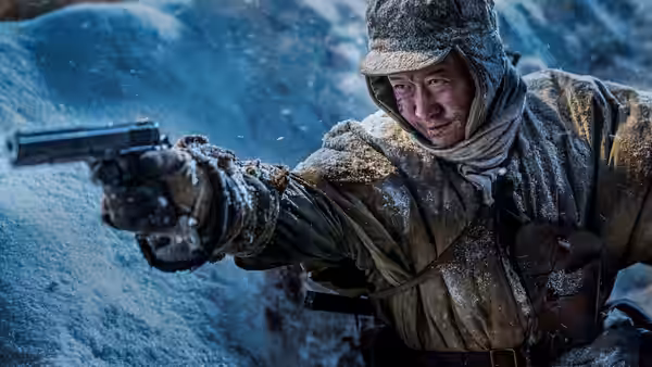 A bundled soldier aims a pistol across a snow-covered battlefield