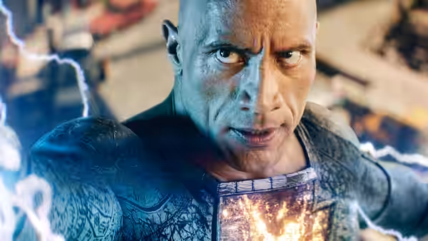 Black Adam stands amid crackling lightning, the emblem on his chest glowing