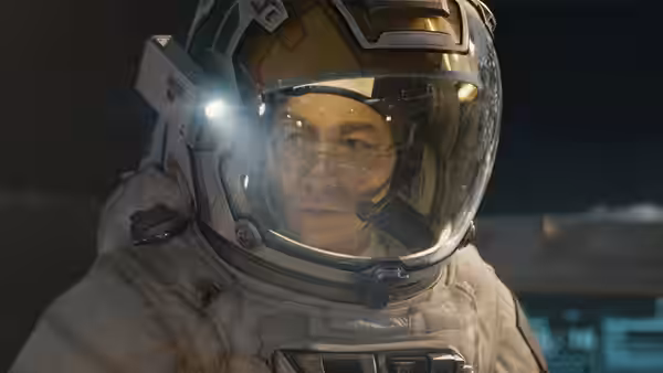 Liu Peiqiang (Wu Jing) in a spacesuit, looking ahead through his helmet visor