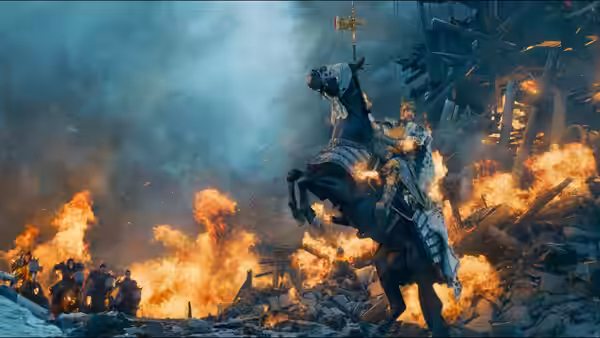 An armored rider on horseback charges through flames and wreckage