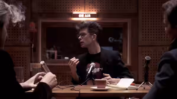 Eddie Limonov (Ben Whishaw) speaks into a microphone in a radio studio