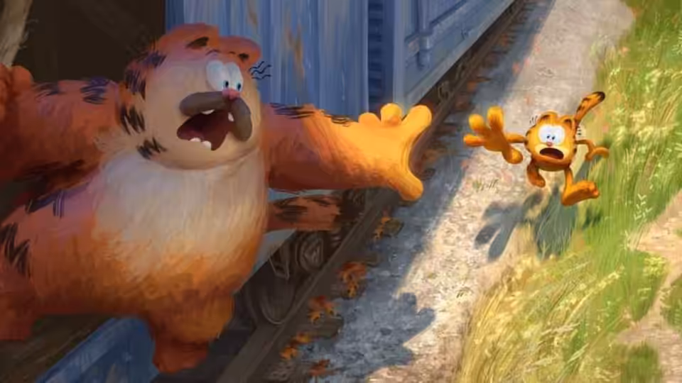 Garfield reaches from a moving train toward a smaller orange cat running beside the tracks