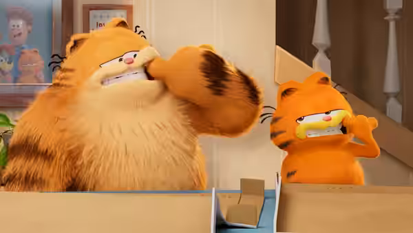 Garfield and another cat grimace at a box on a table indoors