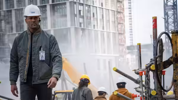 Levon Cade (Jason Statham) walks through a construction site wearing a hard hat