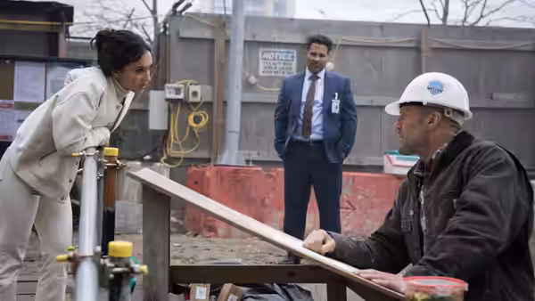 Levon Cade (Jason Statham) talks with a woman at a construction site
