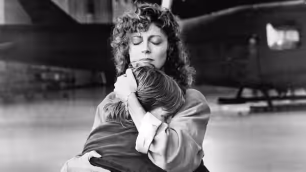 Dianne Sway embraces Mark at an airport terminal