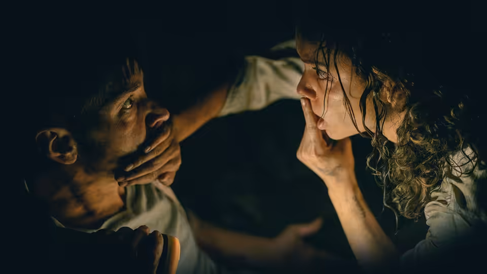 Tess (Georgina Campbell) and a man face each other closely in darkness