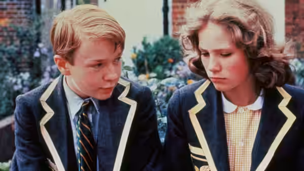 Alan Duckworth (John Albasiny) looks toward Ann Lawton (Abigail Cruttenden) in their school uniforms